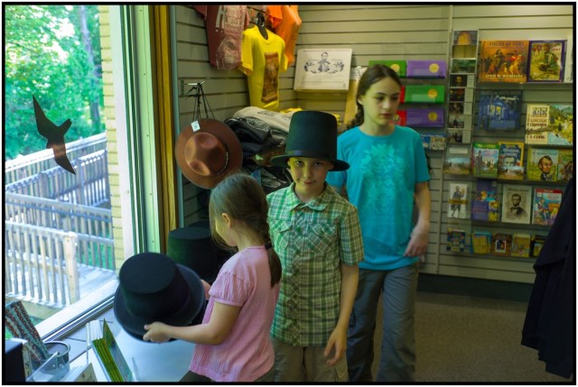 Trying on hats and bonnets in the gift shop