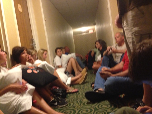Party Central in the 1st floor hallway.  The hotel was "U" shaped and both first floor hallways were designed to be reinforced for storm events.  Everyone is tap-a-tapping on iPhones & etc.  I was able to watch a live TV feed from local TV news on my iPad to watch the storms' progression as it arrived. That thing at the end of the hall is a king sized mattress blocking the hall from possible debris.