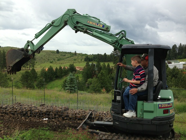 Holden learning to work the back hoe.