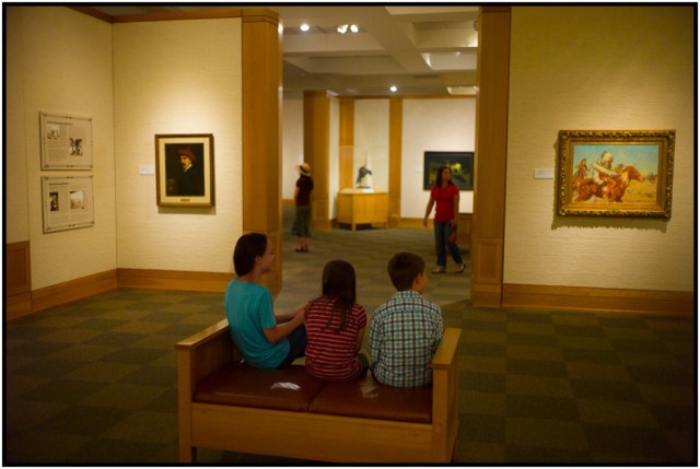 The kids killing some time while Brenda takes in the art (L, in distance).