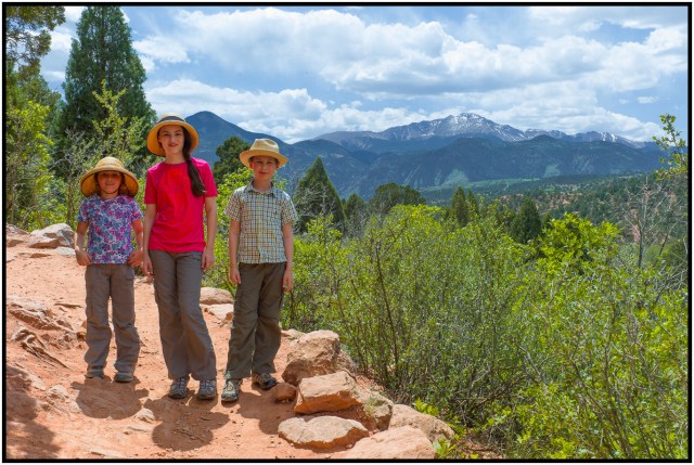 The kids standing in front of Pikes Peak - snow covered in the distance.